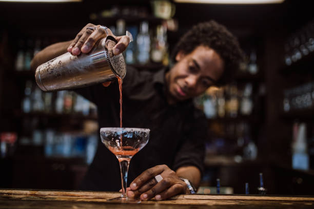 barman is making cocktail at night club
